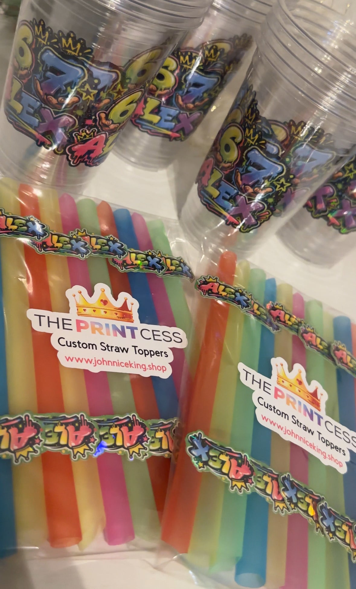 Custom straw toppers on plastic boba straws packed