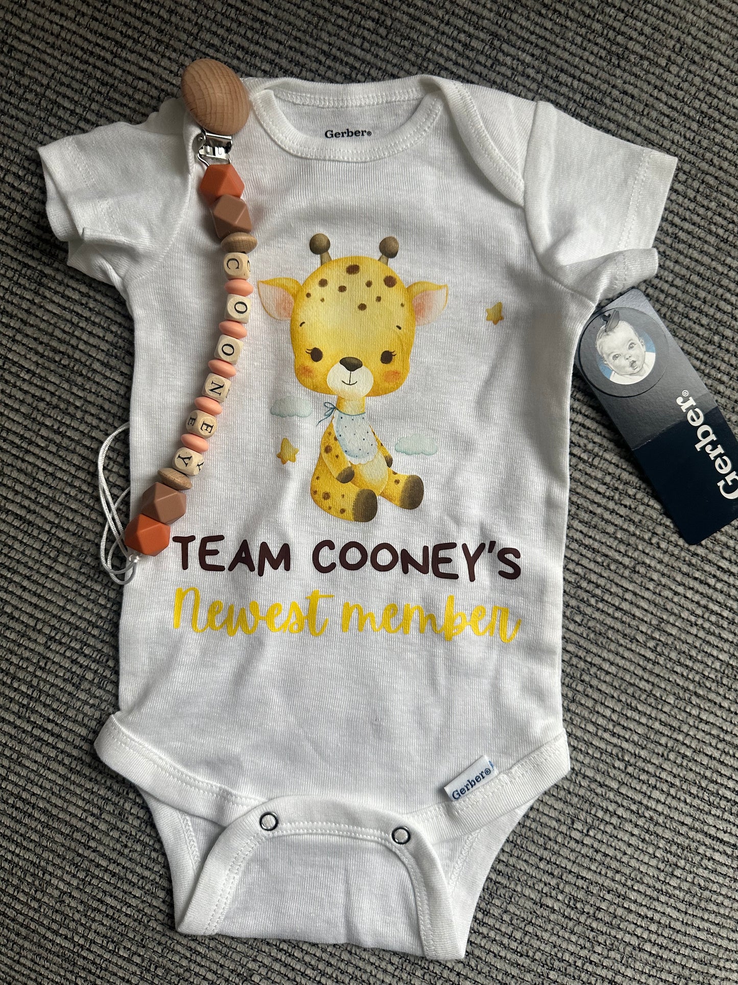 Custom announcement baby onesie with custom bib clip